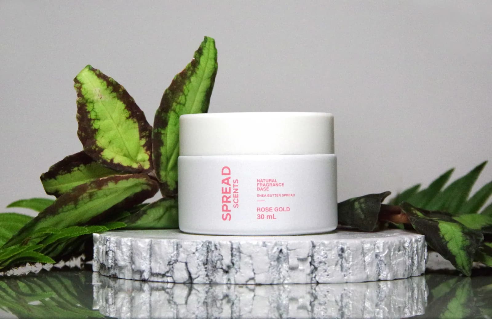 Spread Scents collection — vegan scent balm glass jars and jojoba pocket scent oils on travertine